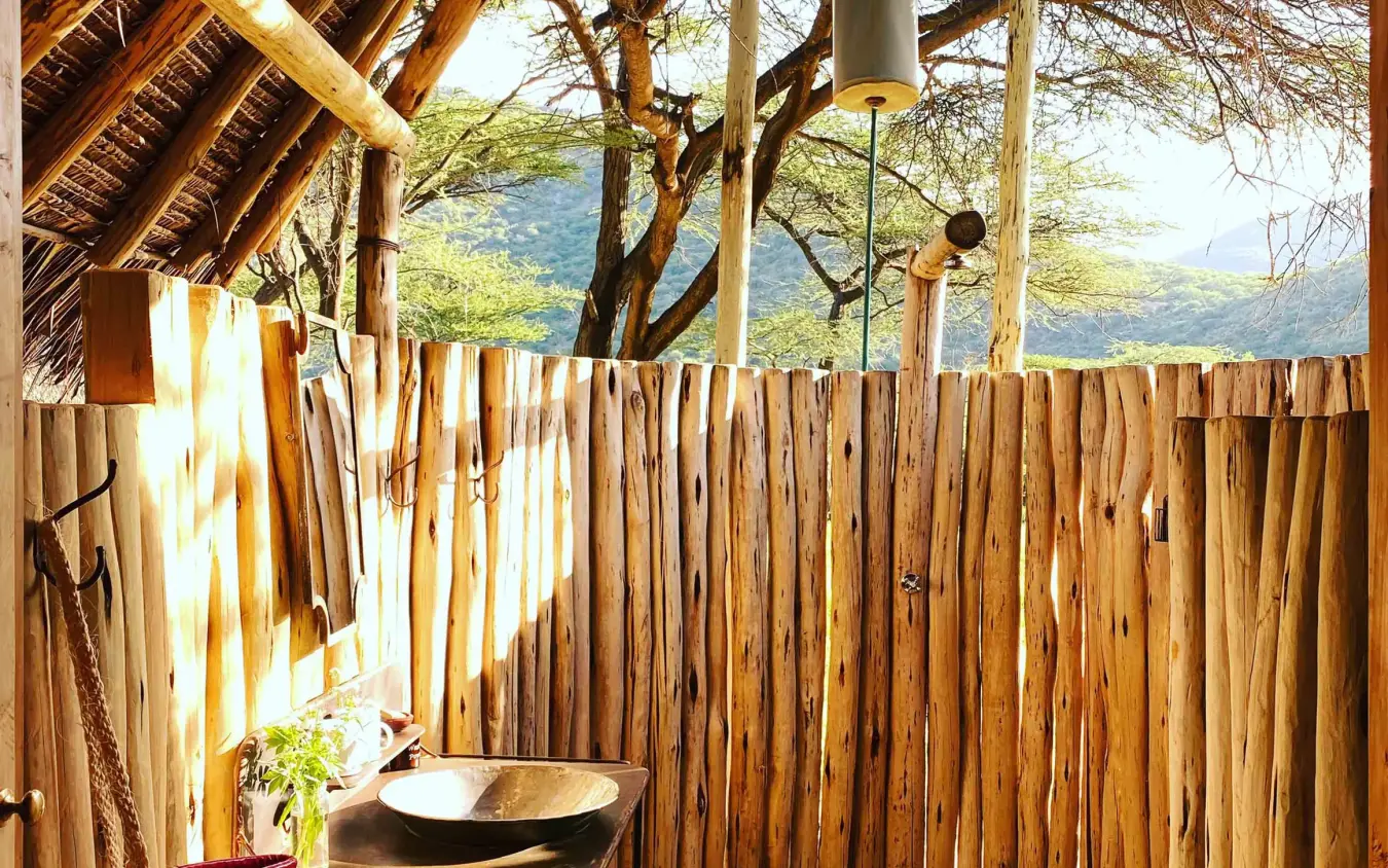 Outdoor shower enclosure with wooden walls and valley view, Koros Camp, Northern Kenya, Kenya