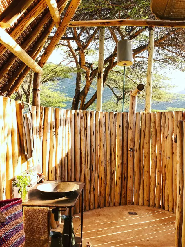 Outdoor shower enclosure with wooden walls and valley view, Koros Camp, Northern Kenya, Kenya