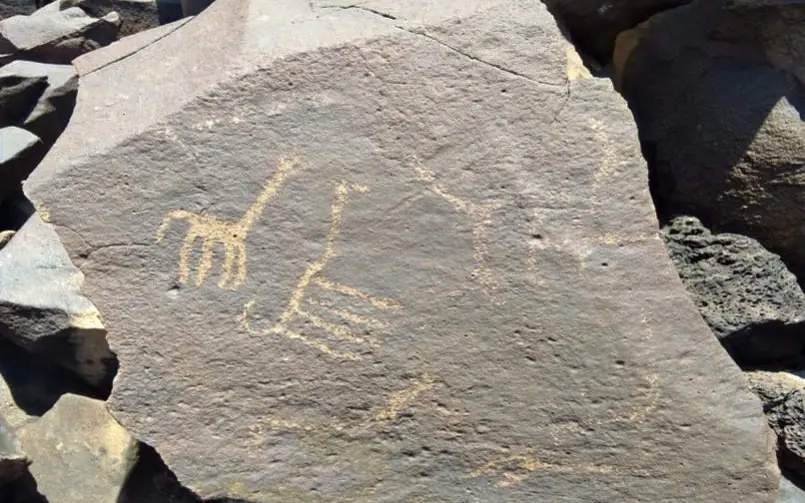 Ancient rock art petroglyph depicting human and animal figures, Koros Camp, Northern Kenya, Kenya