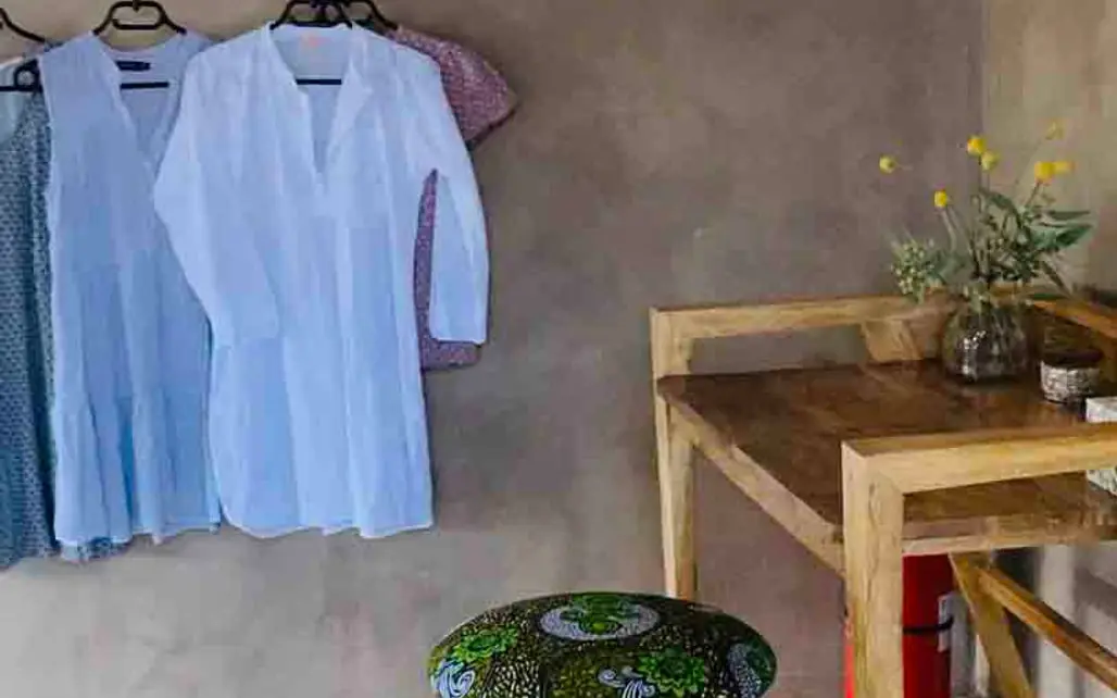 Simple bedroom with wooden furniture and hanging clothes, Koros Camp, Northern Kenya, Kenya