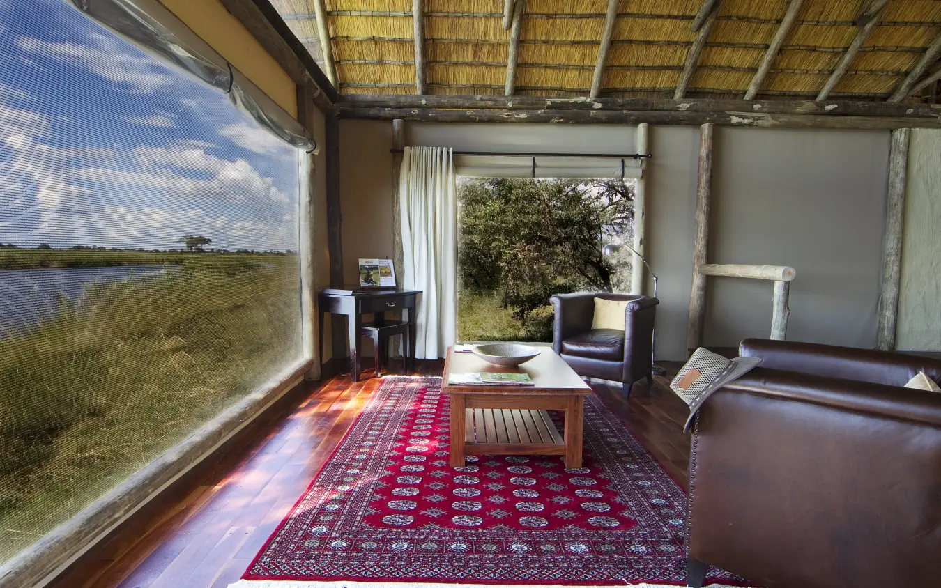 Open-air lodge interior with waterfront views and traditional furnishings, Kwando Lagoon Camp, Linyanti Wildlife Reserve, Botswana