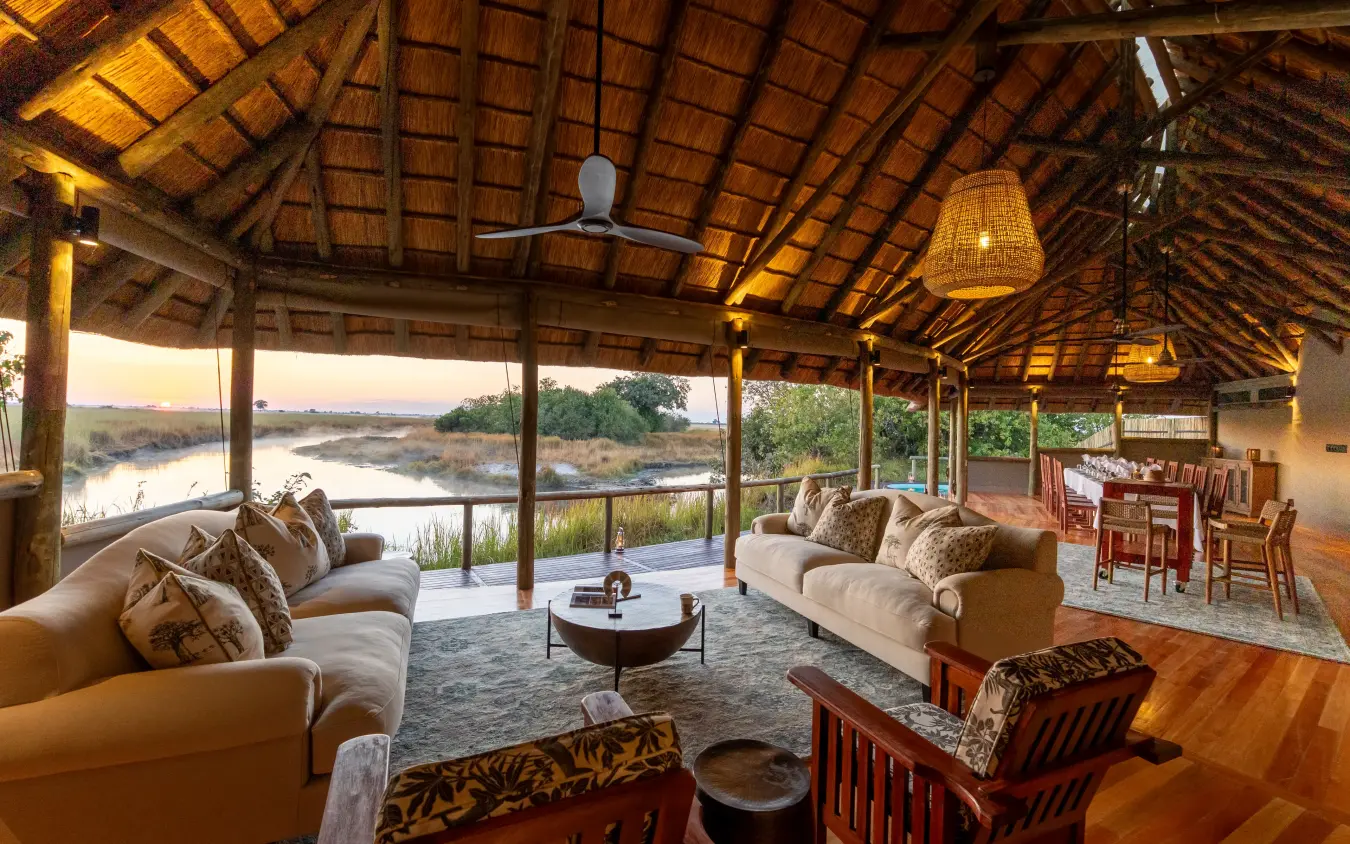 Open-sided lodge lounge overlooking riverine landscape at dusk, Kwando Lebala Camp, Linyanti Wildlife Reserve, Botswana