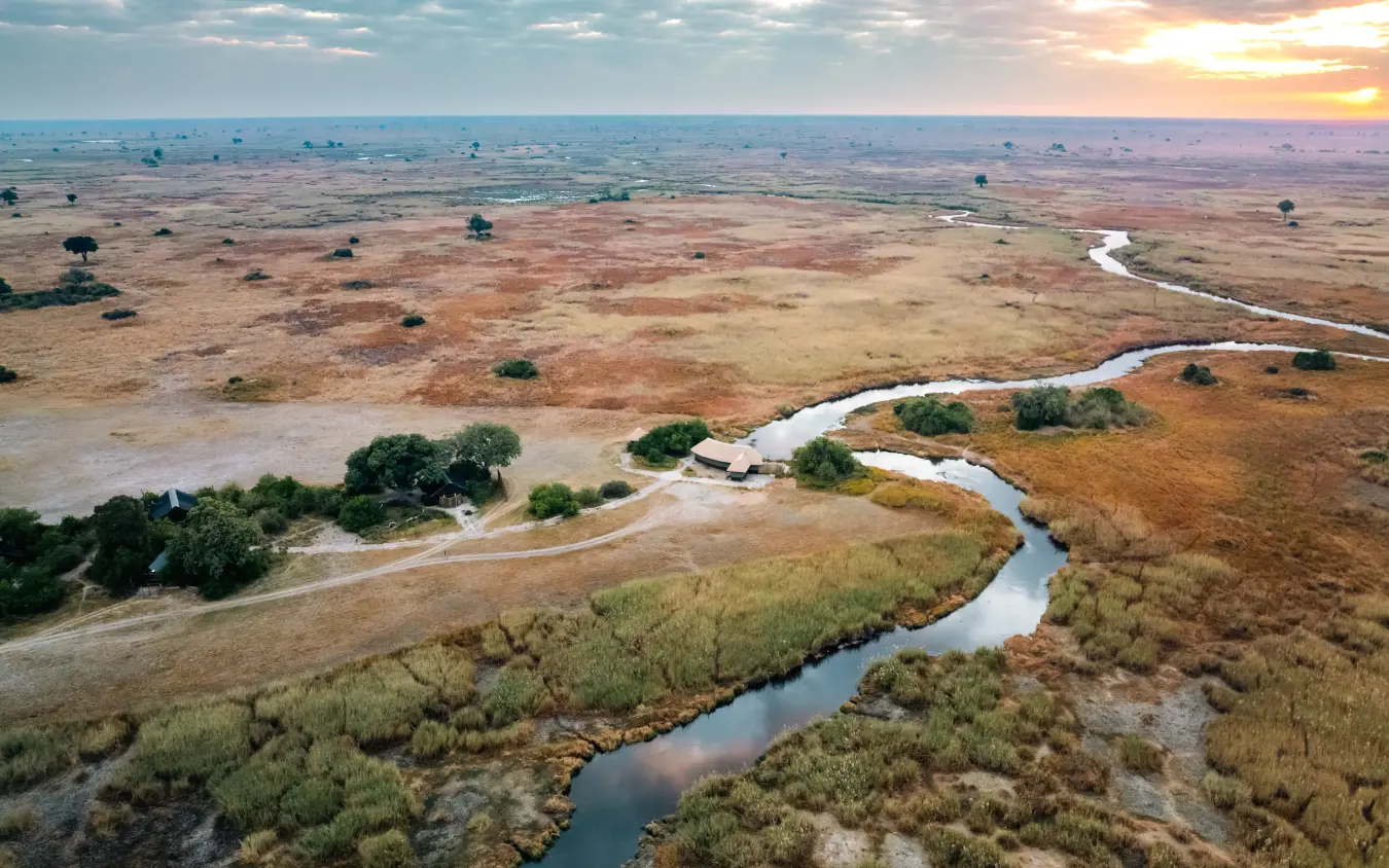 Meandering river through floodplain grassland at sunset from aerial view, Kwando Lebala Camp, Linyanti Wildlife Reserve, Botswana