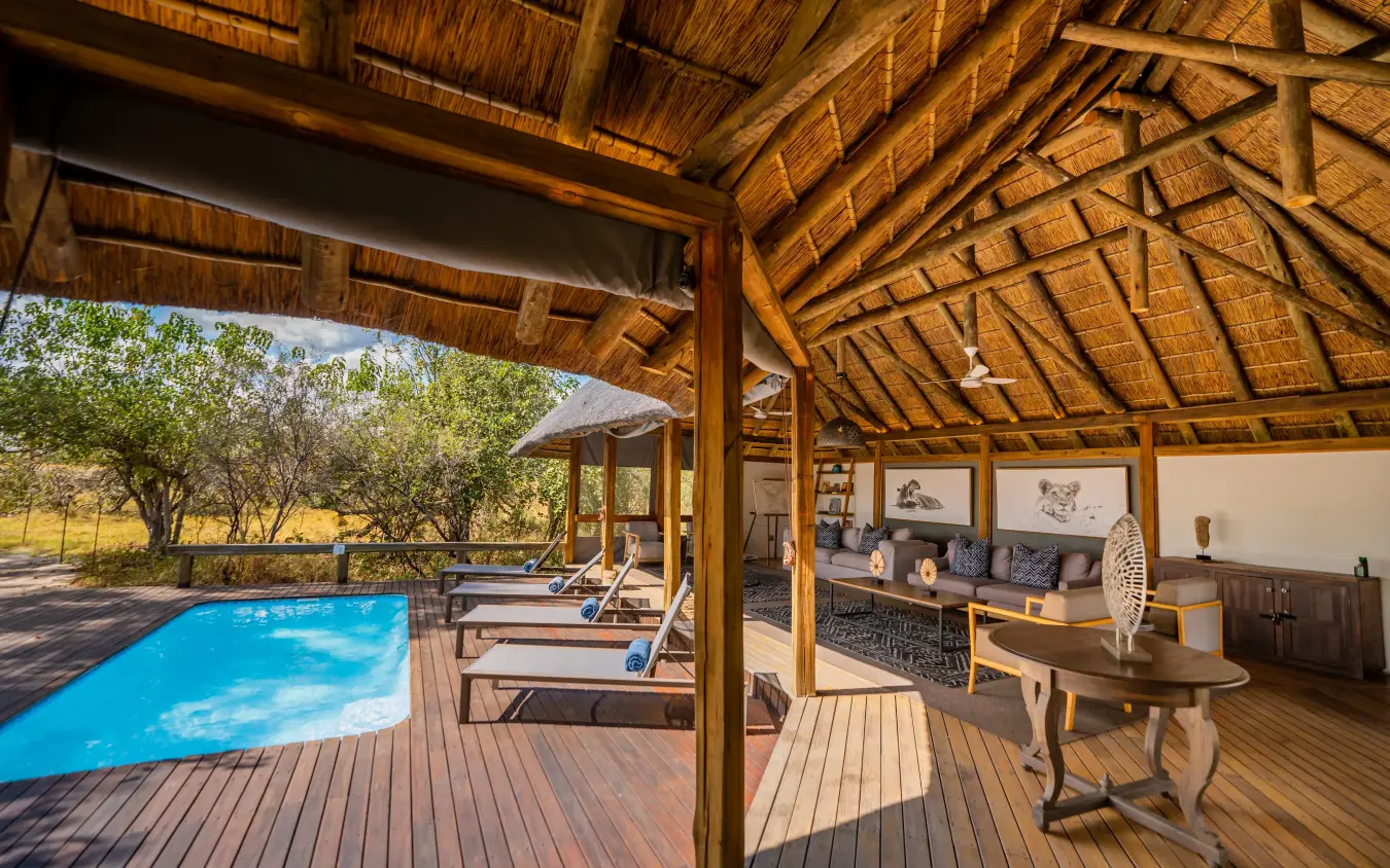 Thatched lodge pavilion with swimming pool and savanna views, Kwando Splash Camp, The Okavango Delta, Botswana