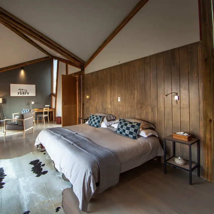 Bedroom suite with wooden beams and deck overlooking natural landscape, Kwando Splash Camp, The Okavango Delta, Botswana