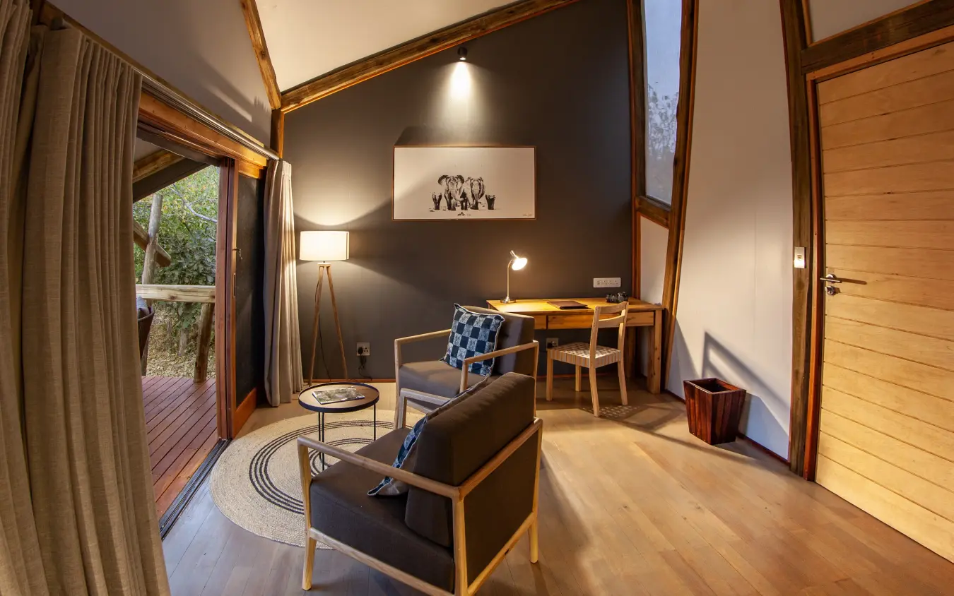 Modern safari lodge suite with wooden furnishings and dark accent wall, Kwando Splash Camp, The Okavango Delta, Botswana