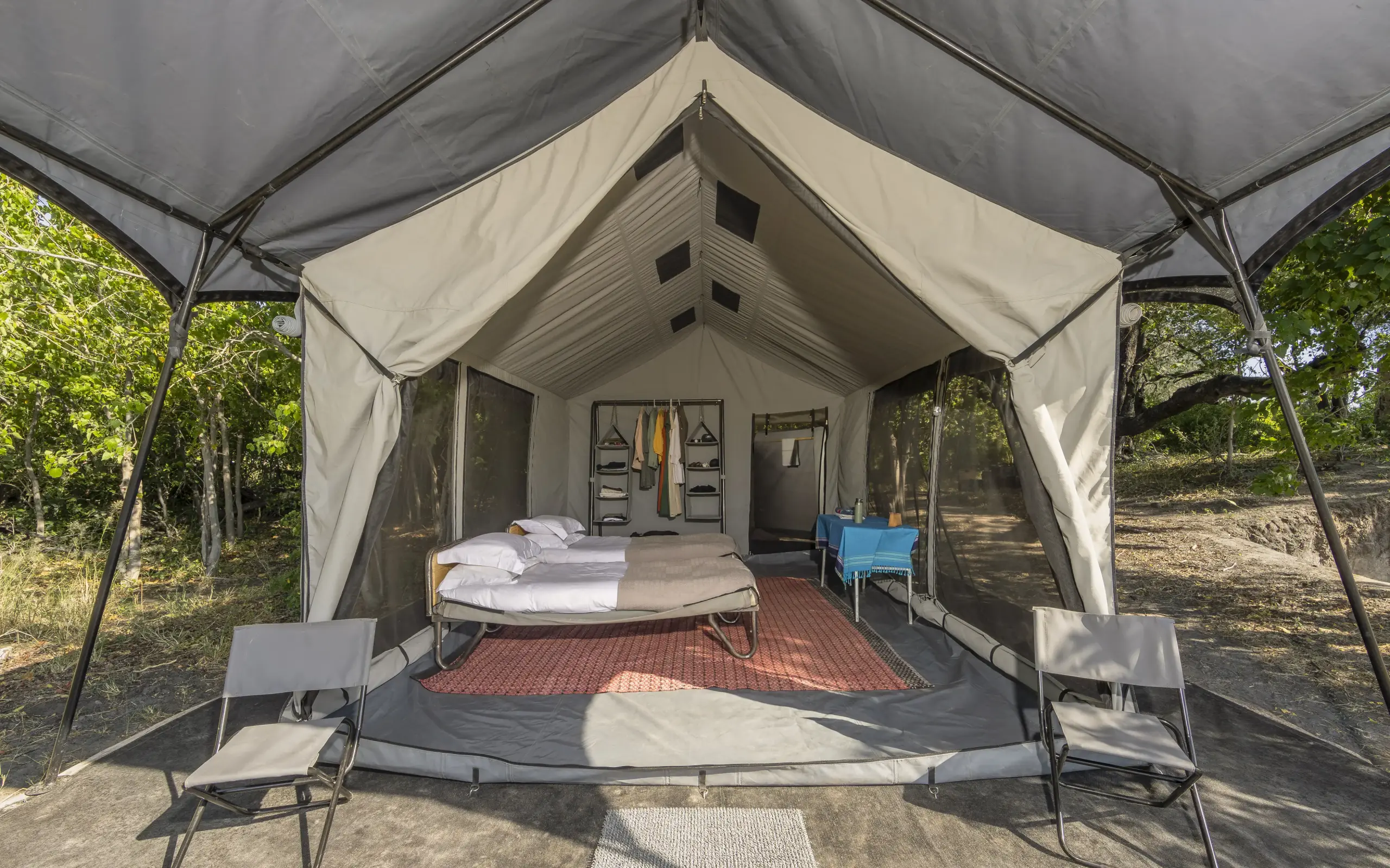 Canvas safari tent with bed and covered wooden deck, Kweene Trails, The Okavango Delta, Botswana