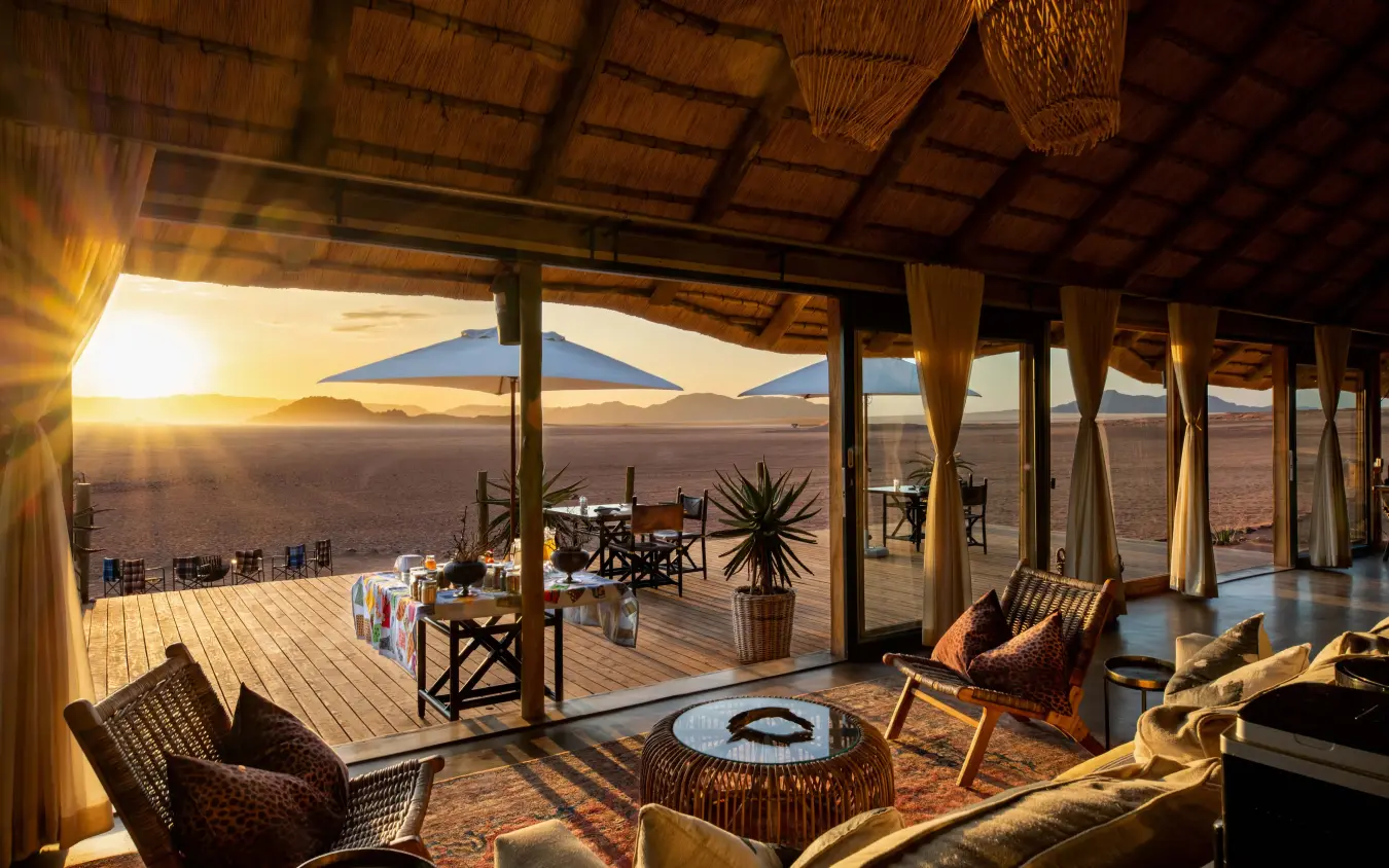 Desert lodge interior with sunset view over vast sandy plains, Kwessi Dunes, NamibRand Private Reserve, Namibia