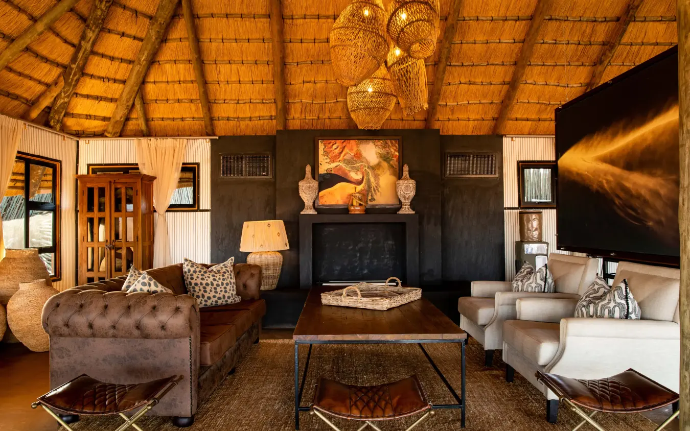 Luxury safari lodge interior with thatched roof and fireplace, Kwessi Dunes, NamibRand Private Reserve, Namibia
