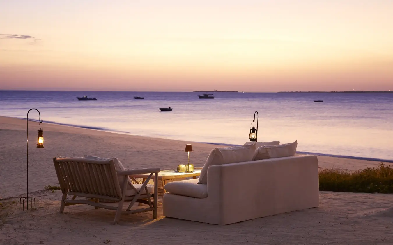 Beachfront seating area with loungers overlooking calm waters at dusk, Laba Fanjove, Zanzibar & Pemba, Tanzania