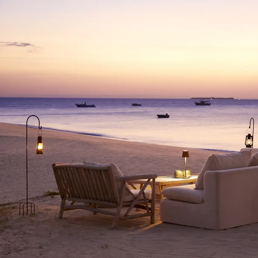 Beachfront seating area with loungers overlooking calm waters at dusk, Laba Fanjove, Zanzibar & Pemba, Tanzania