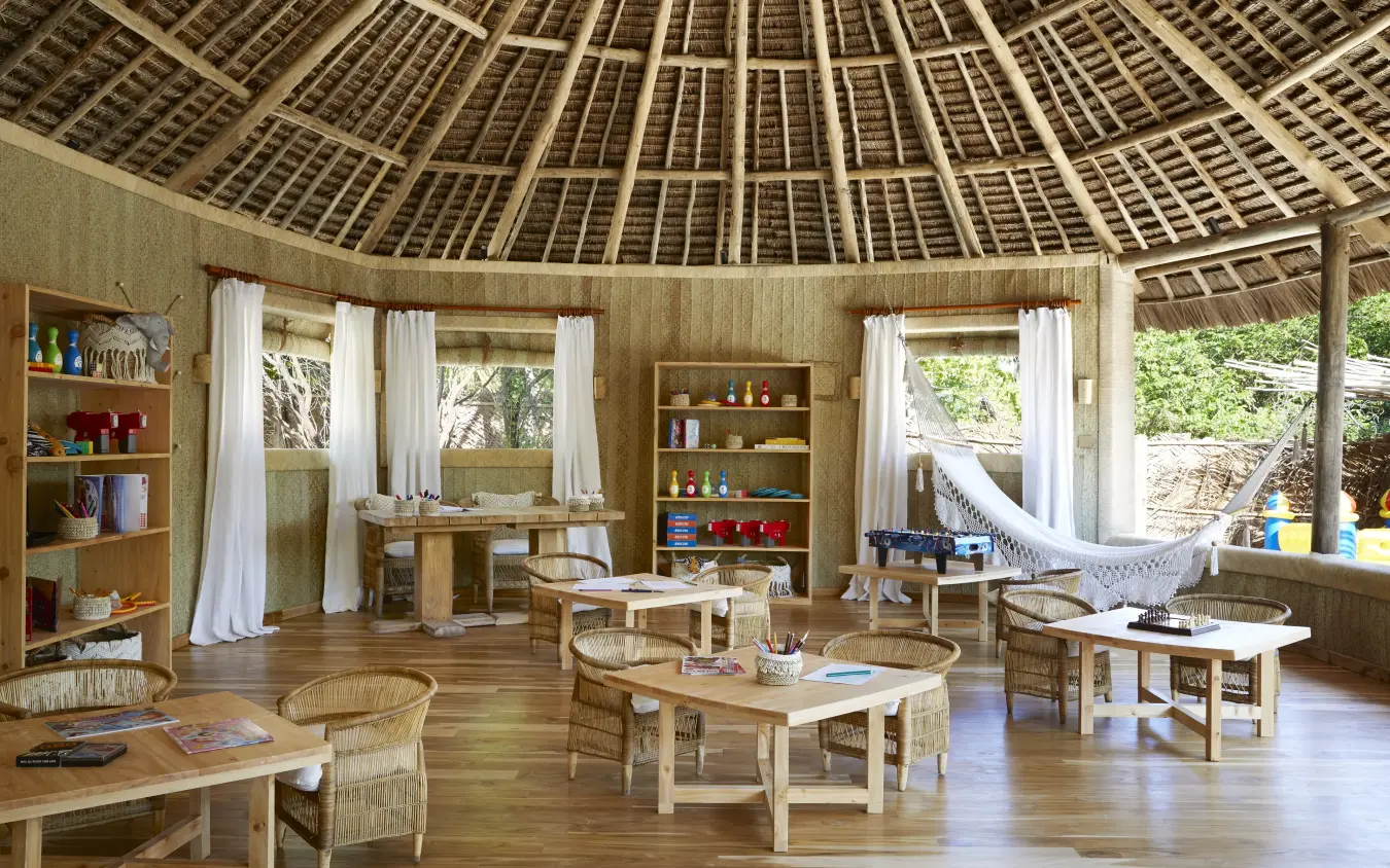 Circular thatched lodge interior with wooden furnishings and open sides, Laba Fanjove, Zanzibar & Pemba, Tanzania
