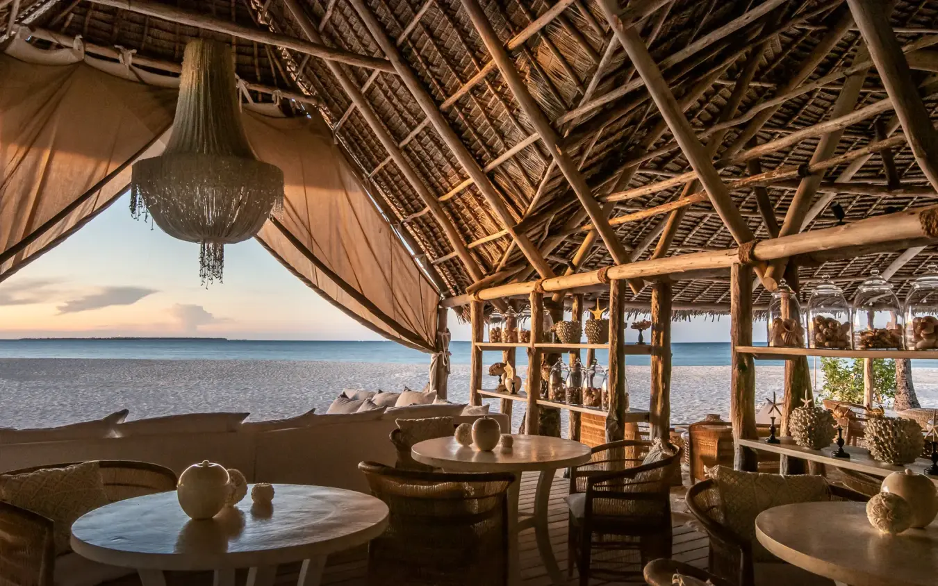 Beachfront dining pavilion with thatched roof overlooking ocean at sunset, Laba Fanjove, Zanzibar & Pemba, Tanzania