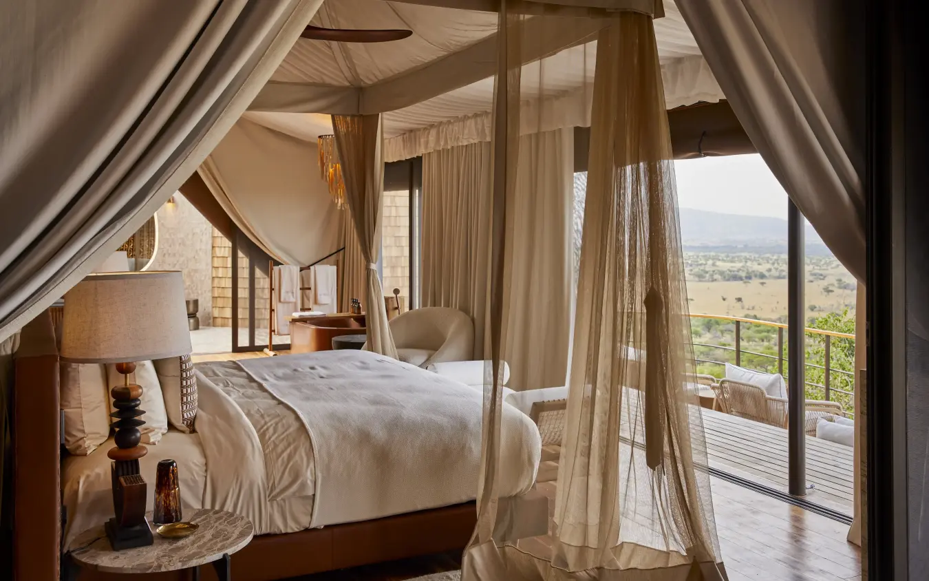 Canopy bed suite with valley views from private deck at sunrise, Laba Grumeti Art Lodge, Serengeti National Park, Tanzania