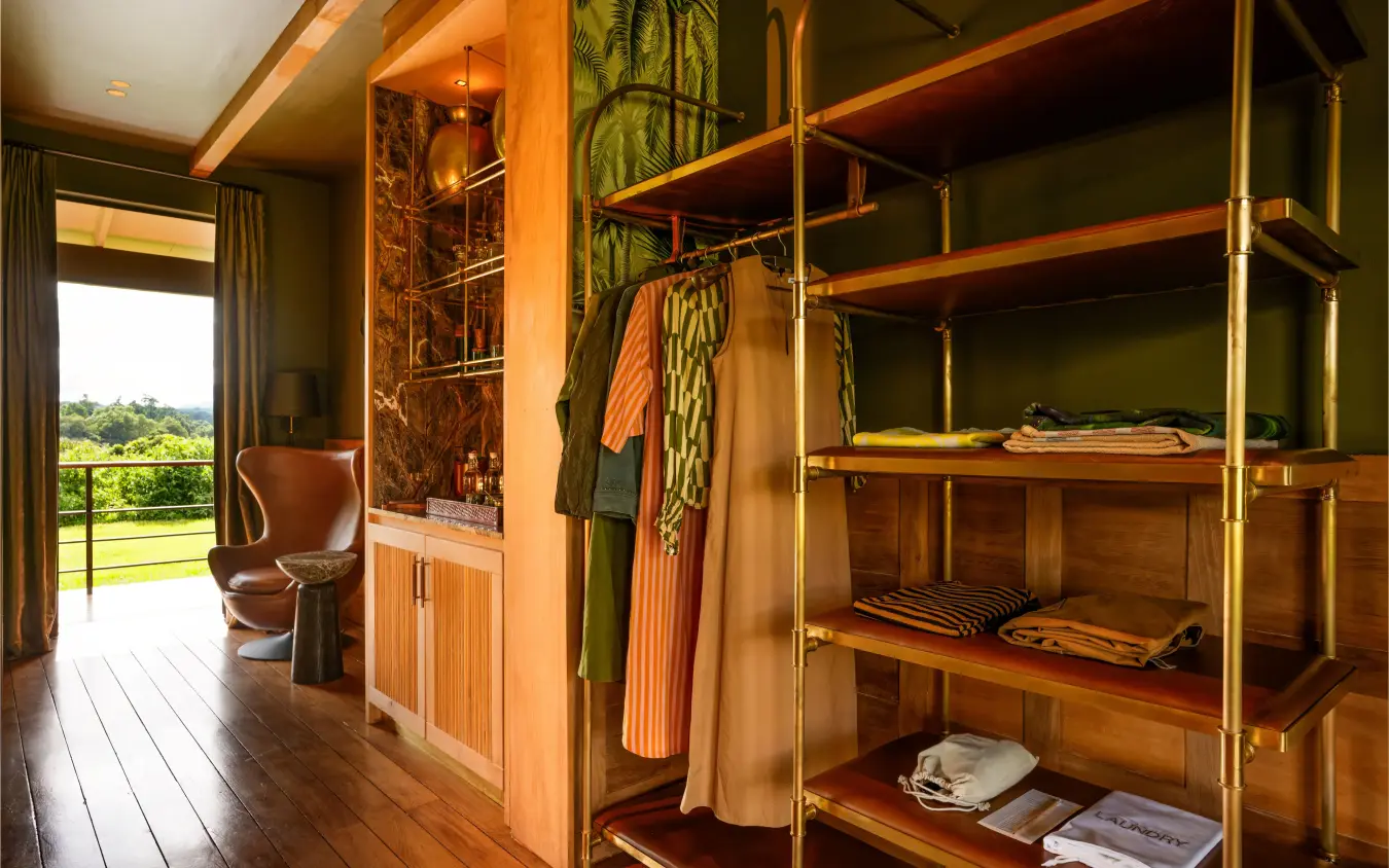 Luxury walk-in wardrobe with wooden shelving and green landscape view, Laba Ngorongoro Lodge, Ngorongoro Crater, Tanzania