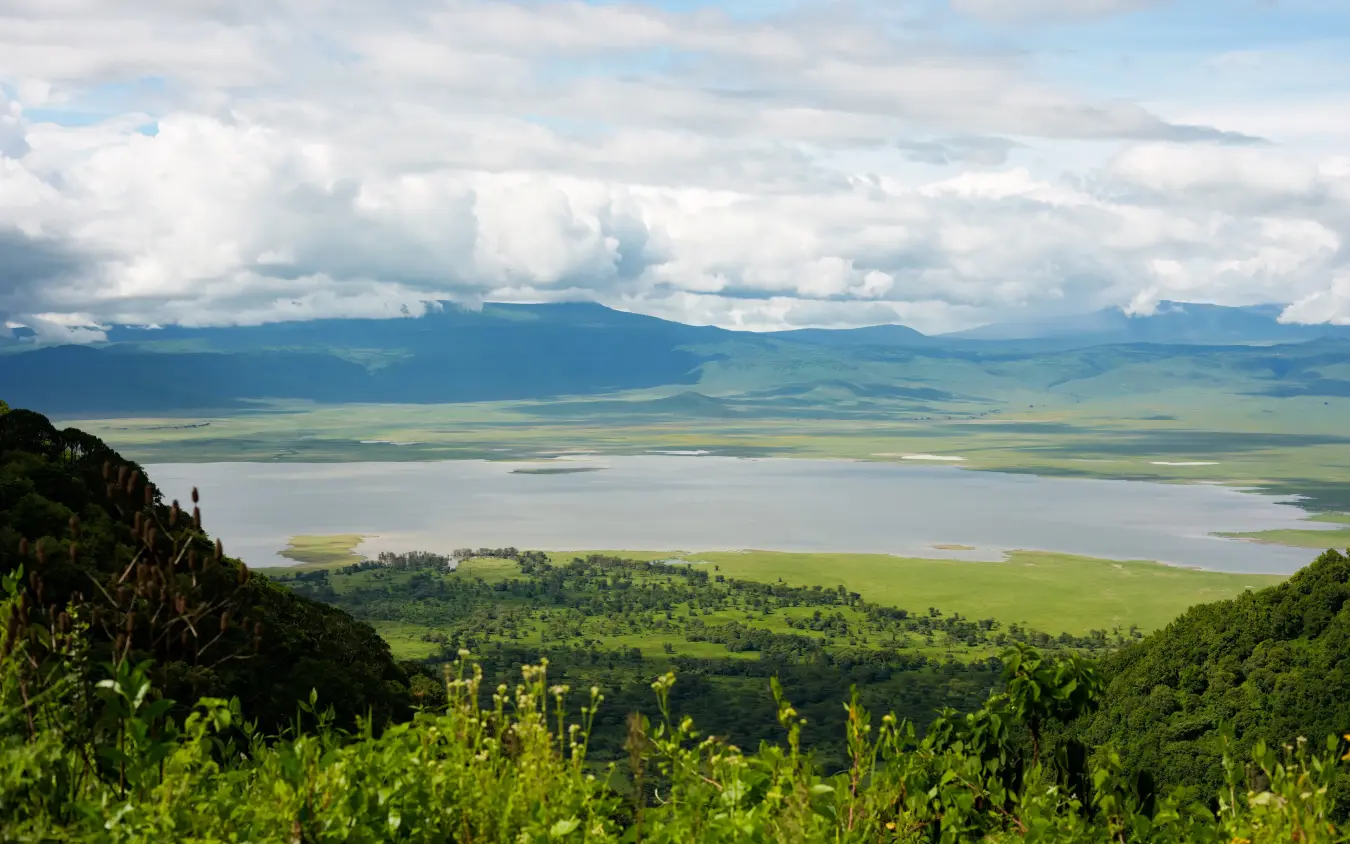 Elevated vista of vast crater lake with forested rim and distant mountains, Laba Ngorongoro Lodge, Ngorongoro Crater, Tanzania