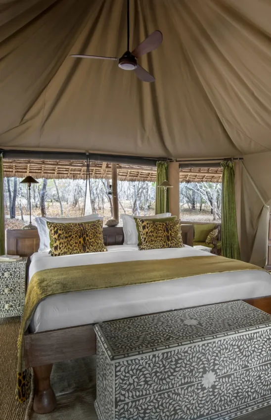 Luxury safari tent bedroom with wildlife-themed decor and canvas interior, Laba Siwandu, Nyerere National Park, Tanzania