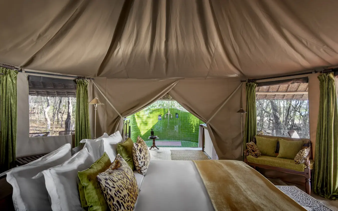 Luxury safari tent bedroom with green accents and forest views, Laba Siwandu, Nyerere National Park, Tanzania