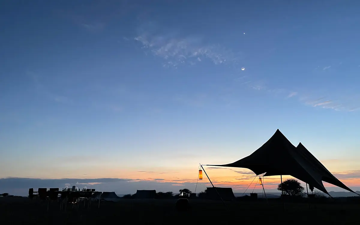 Black canvas tent silhouetted against sunset sky, Karisia Walking Safaris, Laikipia Highlands, Kenya