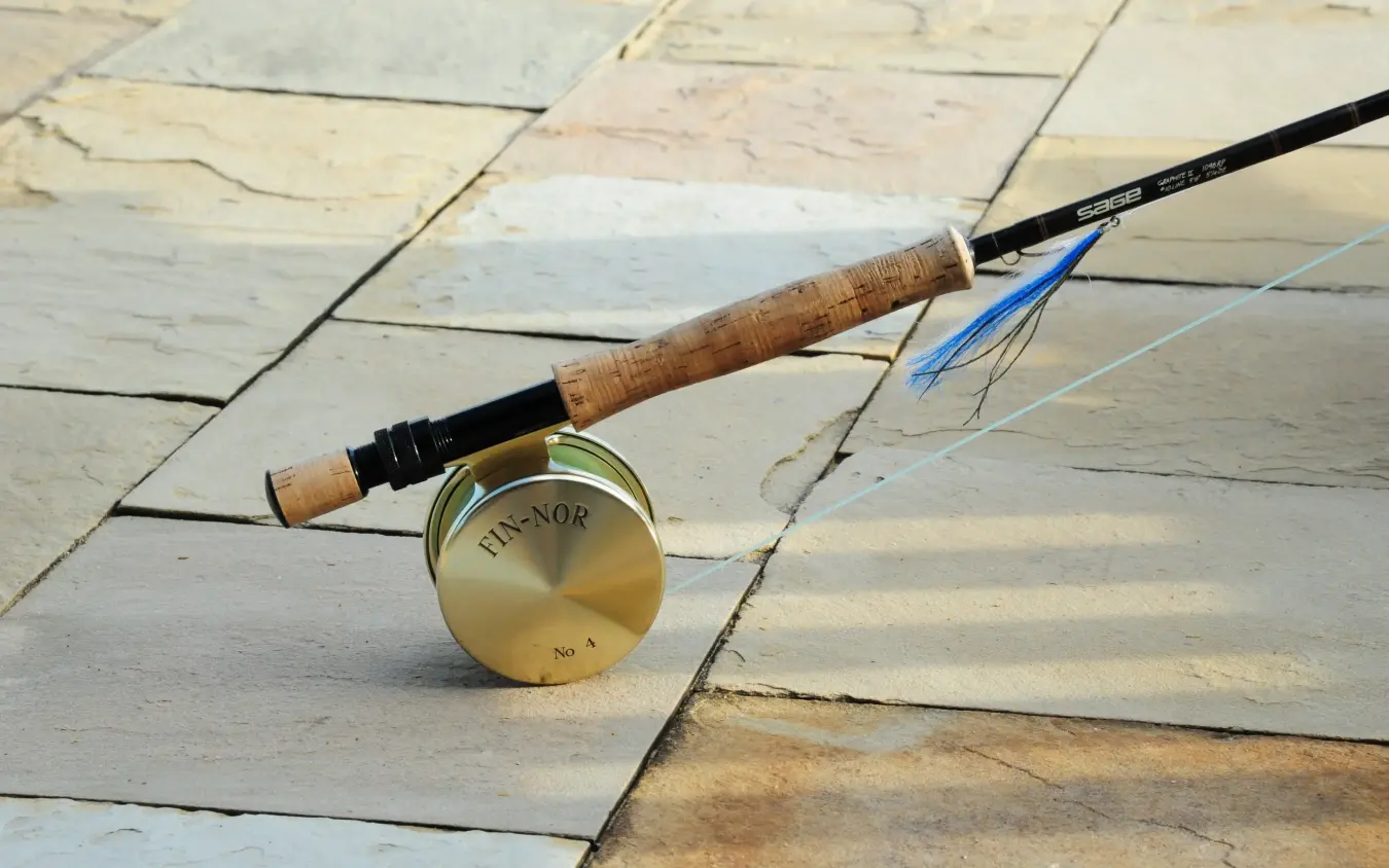 Fly fishing rod and reel on stone deck, Karisia Walking Safaris, Laikipia Highlands, Kenya