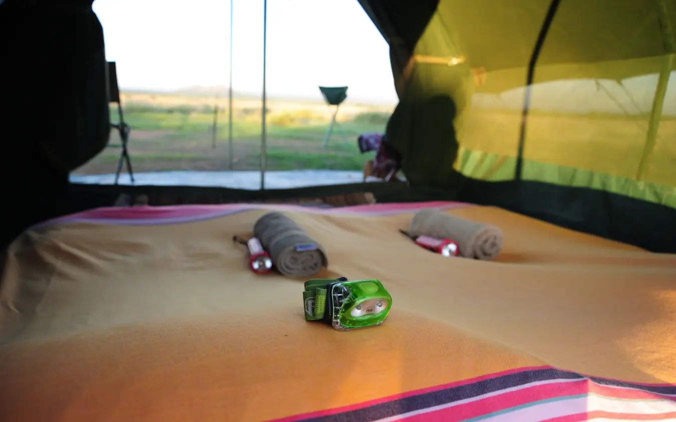 Toy vehicles on canvas inside safari tent, Karisia Walking Safaris, Laikipia Highlands, Kenya