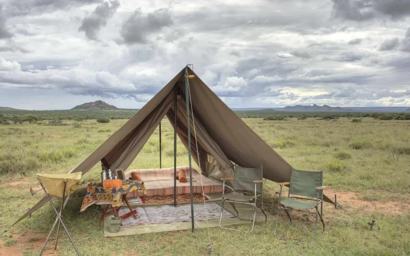 Canvas safari tent pitched in open savanna landscape, Karisia Walking Safaris, Laikipia Highlands, Kenya