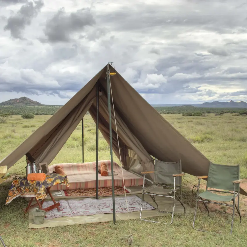 Canvas safari tent pitched in open savanna landscape, Karisia Walking Safaris, Laikipia Highlands, Kenya