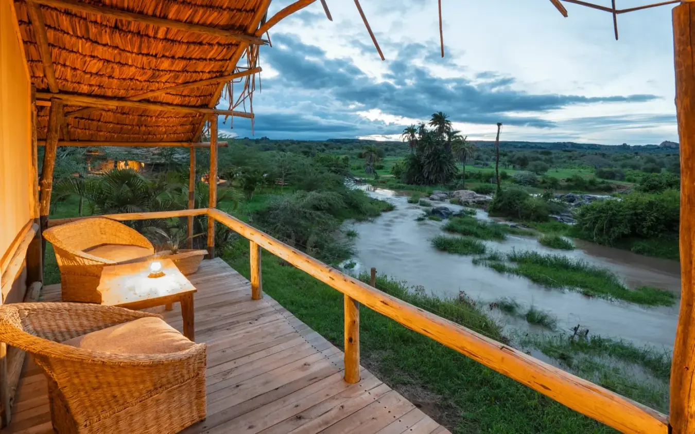 Wooden deck overlooking river and savanna landscape at dusk, Laikipia Wilderness, Laikipia Highlands, Kenya
