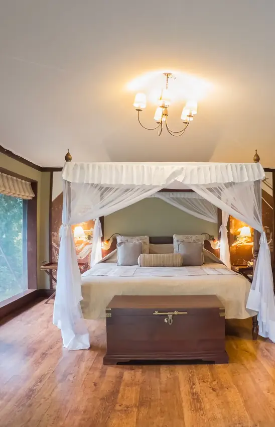 Four-poster bed with white drapes in luxury bedroom suite, Lake Elmenteita Serena Camp, Rift Valley Lakes, Kenya