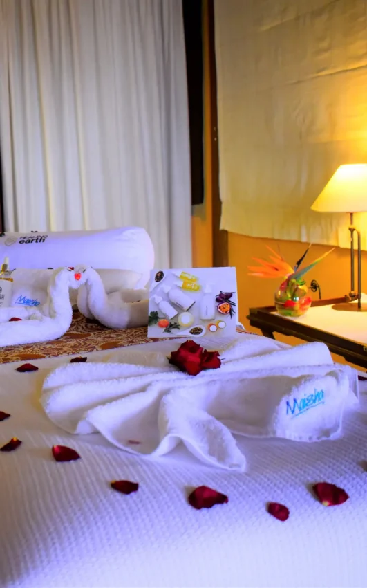 Bed decorated with towel animals and rose petals in luxury hotel room, Lake Elmenteita Serena Camp, Rift Valley Lakes, Kenya