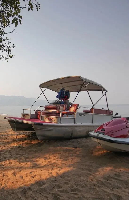 Colorful boats and water sports equipment on sandy beach, Lake Kivu Serena Hotel, Lake Kivu, Rwanda