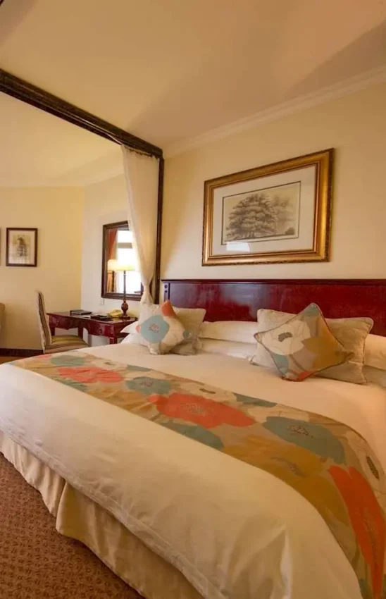 Spacious bedroom with four-poster bed and lake views, Lake Kivu Serena Hotel, Lake Kivu, Rwanda