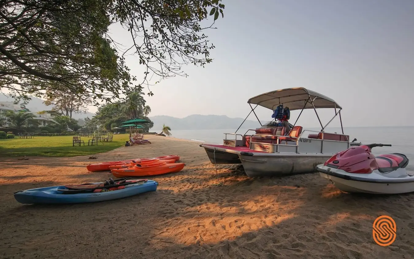 Colorful boats and water sports equipment on sandy beach, Lake Kivu Serena Hotel, Lake Kivu, Rwanda