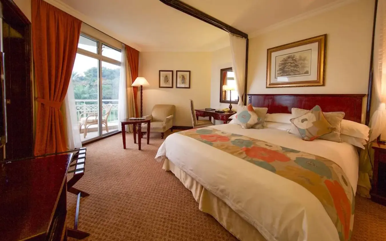 Spacious bedroom with four-poster bed and lake views, Lake Kivu Serena Hotel, Lake Kivu, Rwanda