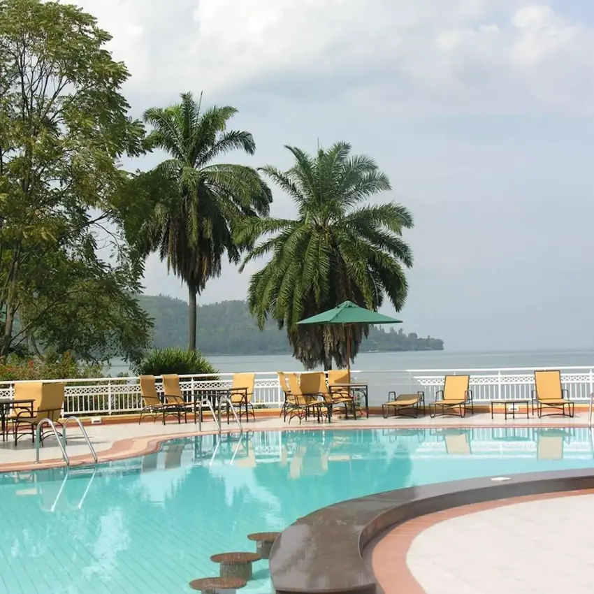 Lakeside swimming pool with lounge chairs and palm trees, Lake Kivu Serena Hotel, Lake Kivu, Rwanda