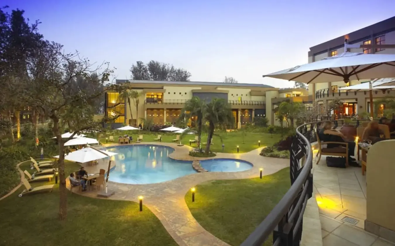 Swimming pool and grounds at dusk with resort buildings, Lake Kivu Serena Hotel, Lake Kivu, Rwanda