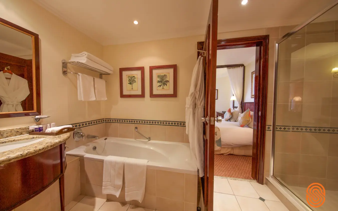 Luxurious bathroom with soaking tub, walk-in shower and adjoining bedroom, Lake Kivu Serena Hotel, Lake Kivu, Rwanda