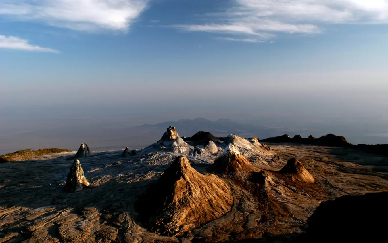 Golden volcanic peaks and crater formations at sunrise, Lake Natron Camp, Lake Natron, Tanzania