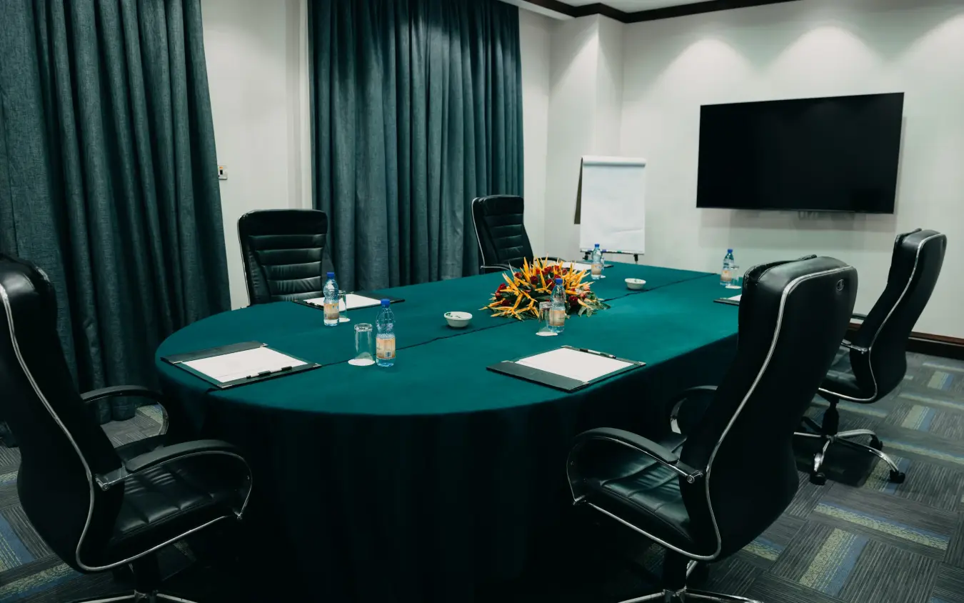 Conference room with oval teal table and black leather chairs, Lake Victoria Serena Golf Resort & Spa, Entebbe and Kampala, Uganda
