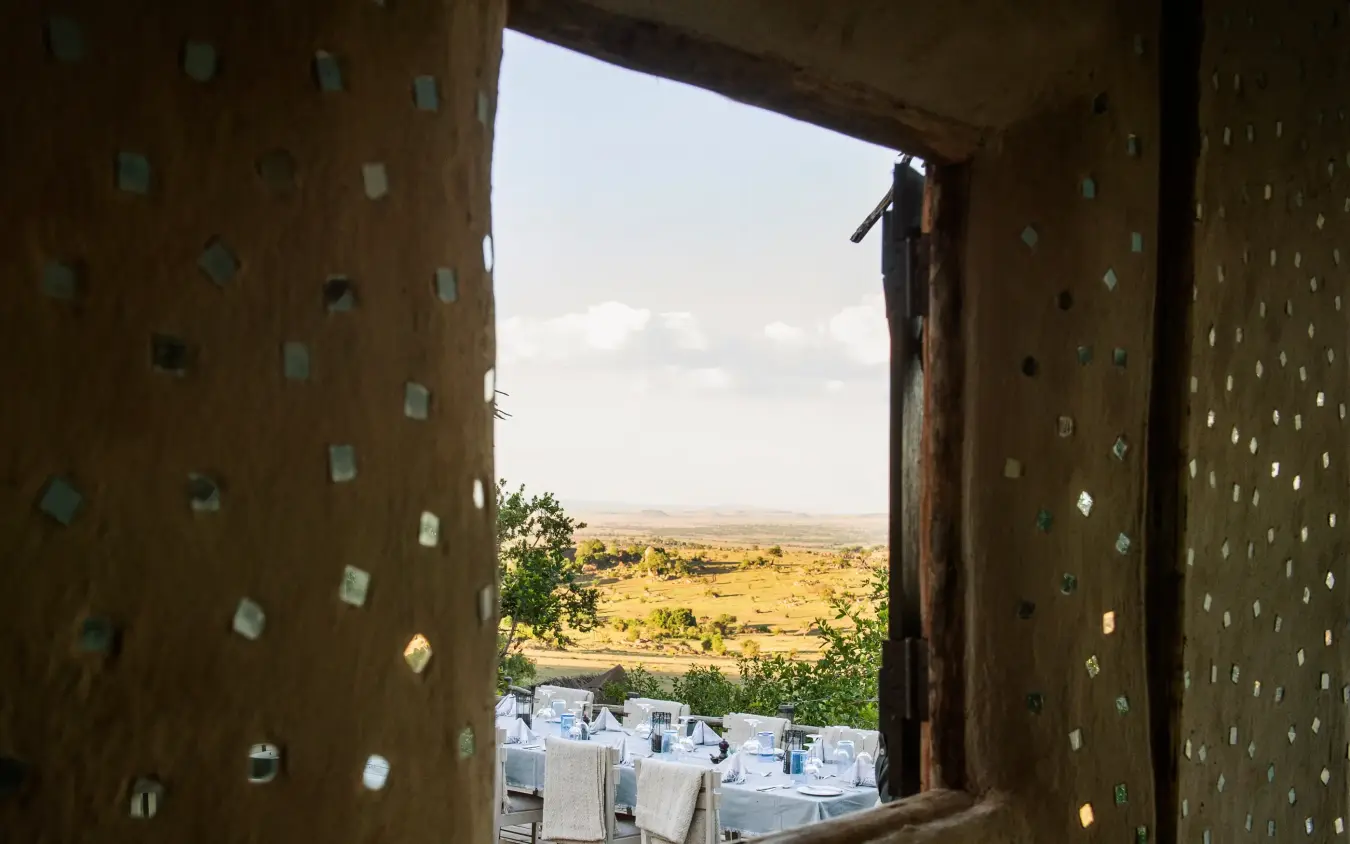 View through stone window frame to savanna landscape, Lamai Serengeti, Serengeti National Park, Tanzania