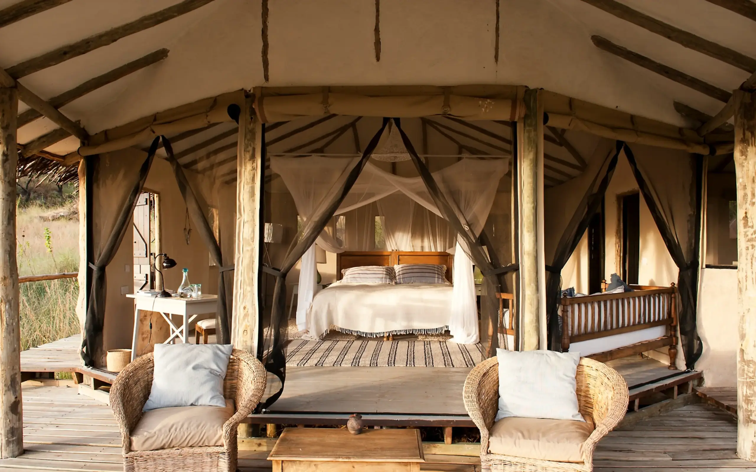 Spacious safari tent bedroom with four-poster canopy bed, Lamai Serengeti, Serengeti National Park, Tanzania