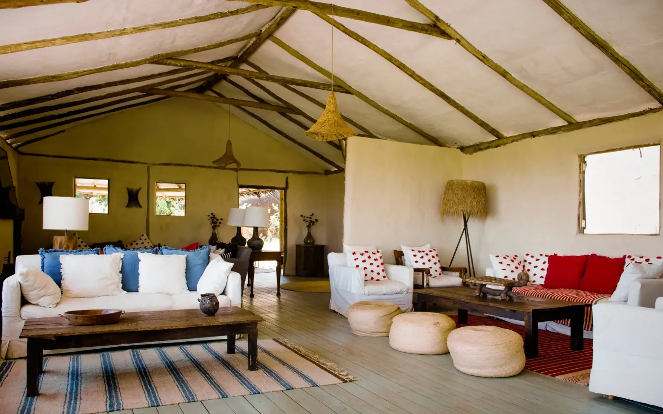 Open-air canvas tent lounge with seating areas and natural light, Lamai Serengeti, Serengeti National Park, Tanzania