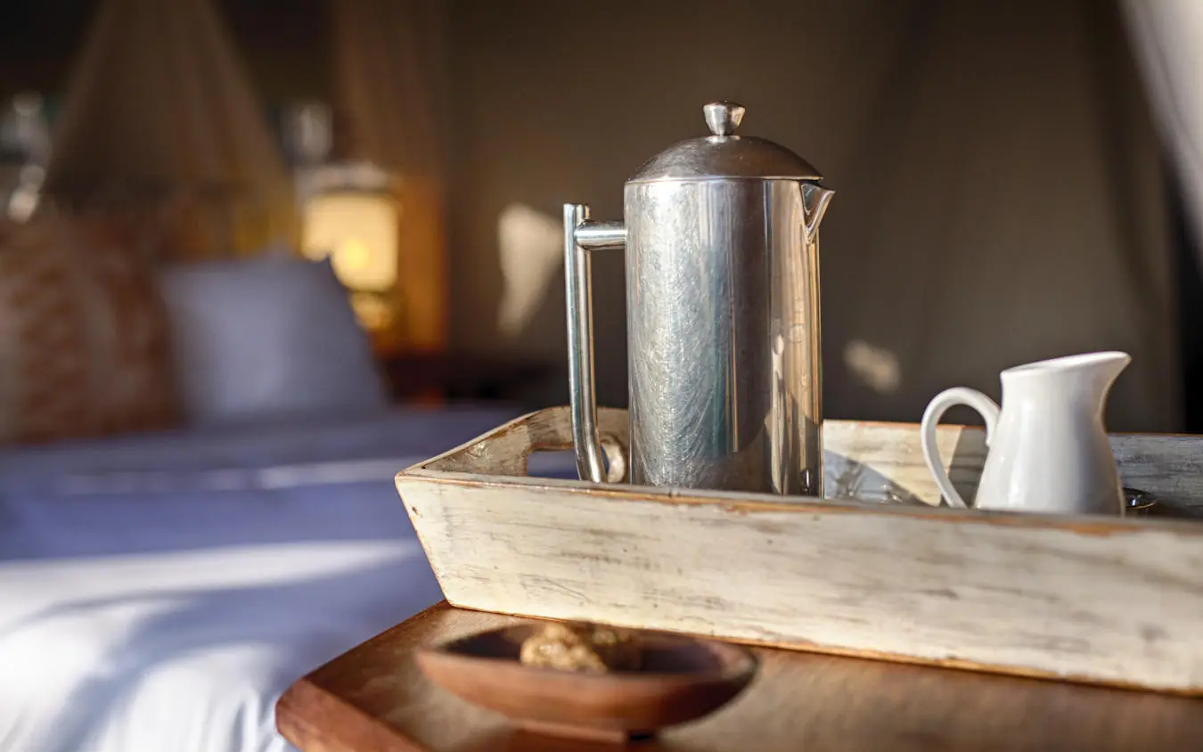 Coffee service on wooden tray in bedroom setting, Serian Serengeti Lamai, Serengeti National Park, Tanzania