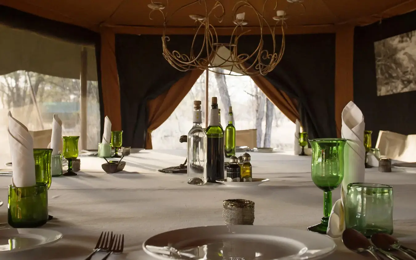 Elegant dining room with table settings and wine bottles, Serian Serengeti Lamai, Serengeti National Park, Tanzania