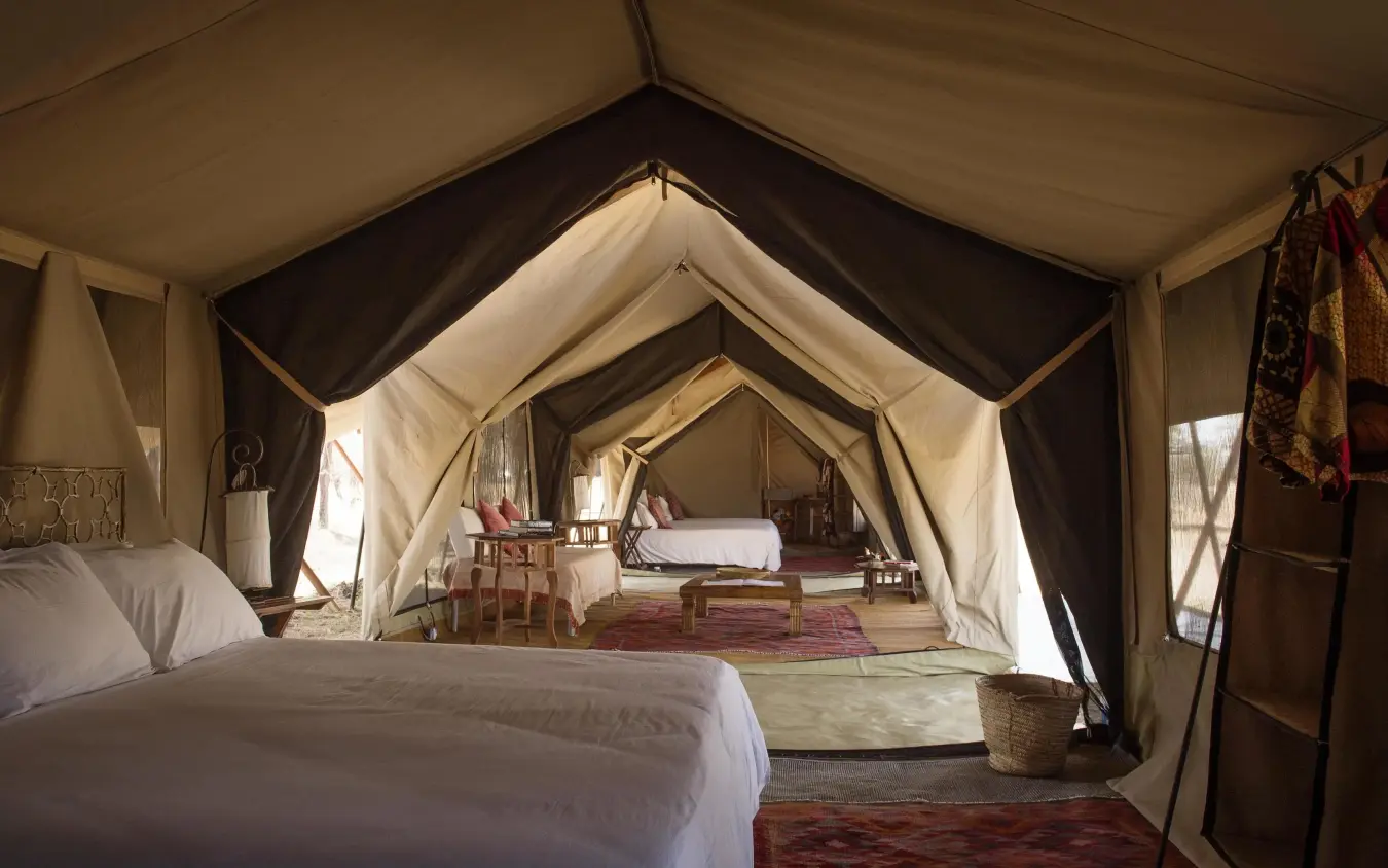 Interior view of canvas safari tent with layered fabric design, Serian Serengeti Lamai, Serengeti National Park, Tanzania