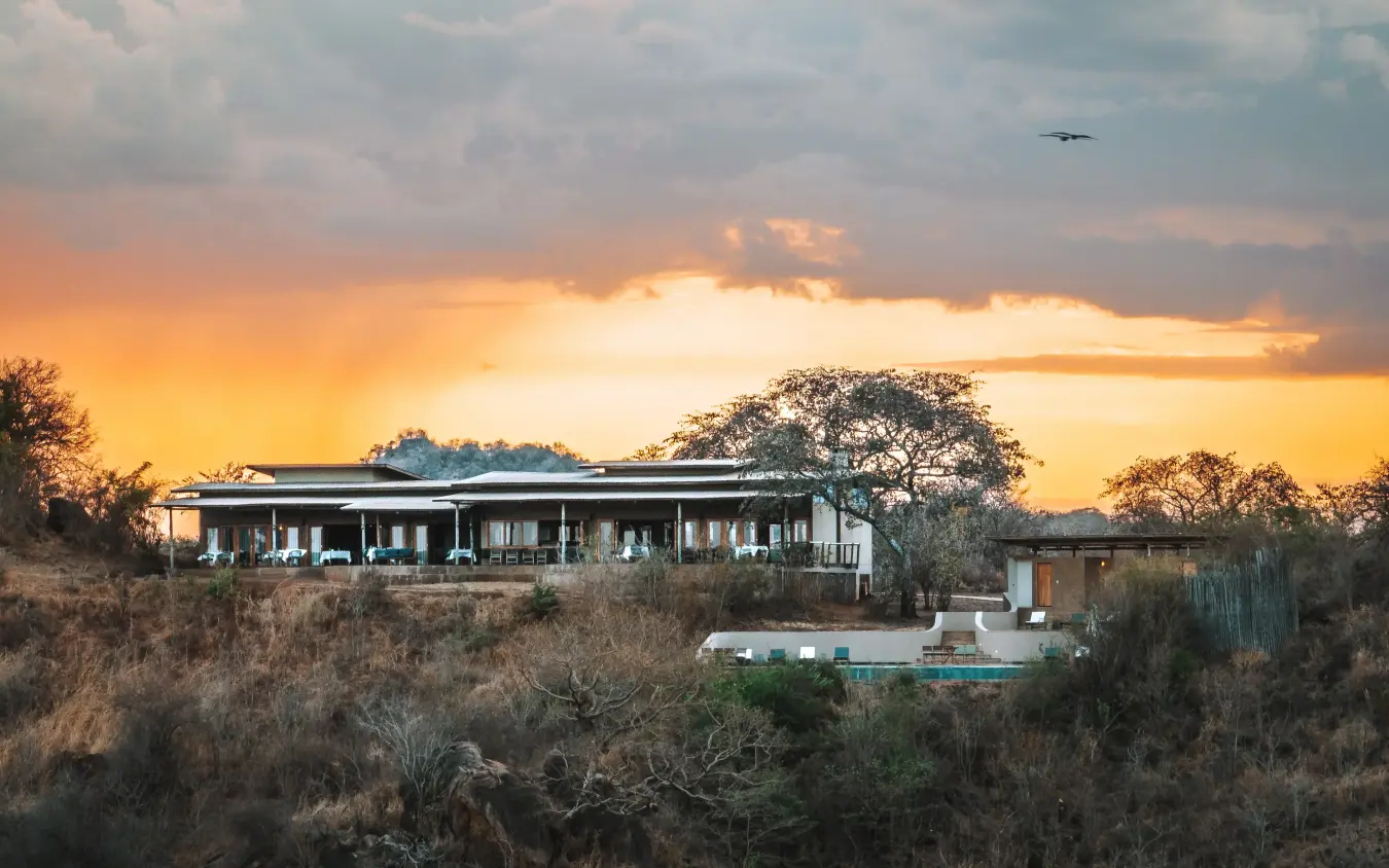 Modern safari lodge perched on hillside at sunset with surrounding bushland, Mpingo Ridge Lodge, Tarangire National Park, Tanzania