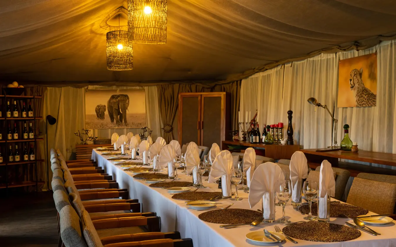 Elegant dining tent with long table and wildlife artwork, Lemala Ngorongoro, Ngorongoro Crater, Tanzania