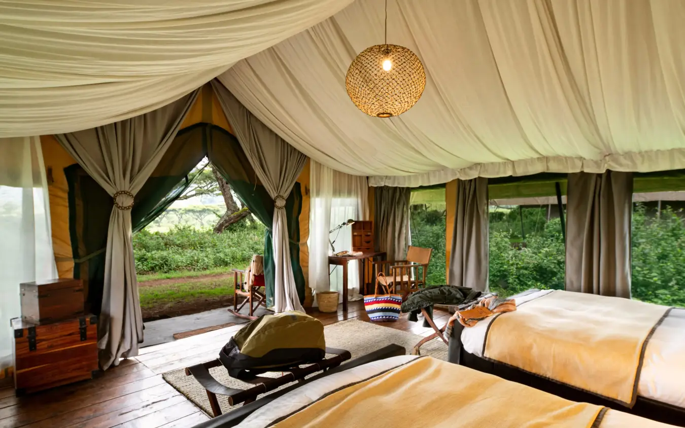 Spacious safari tent bedroom with draped canvas ceiling and open views, Lemala Ngorongoro, Ngorongoro Crater, Tanzania