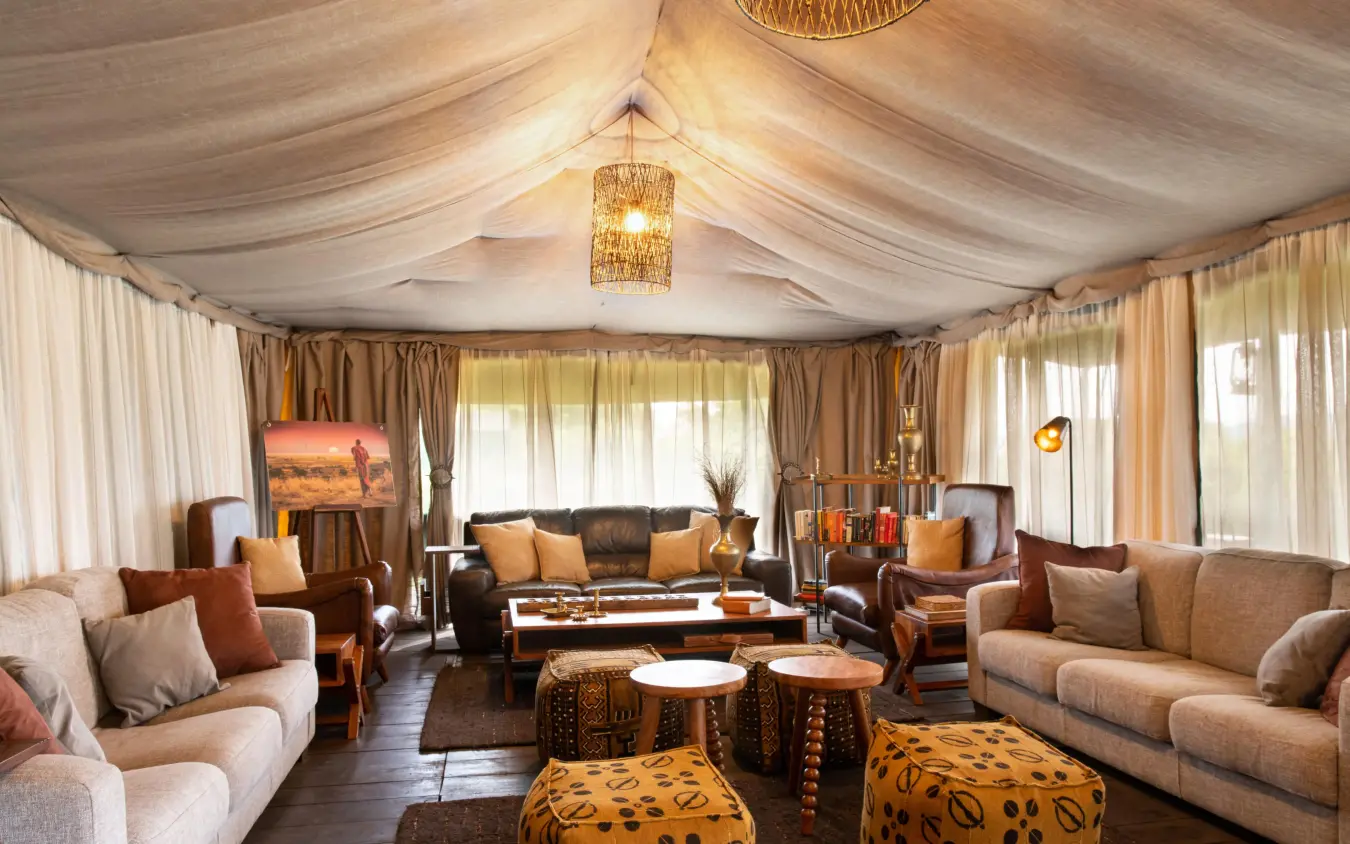 Spacious tent lounge with cream furnishings and warm lighting, Lemala Ngorongoro, Ngorongoro Crater, Tanzania