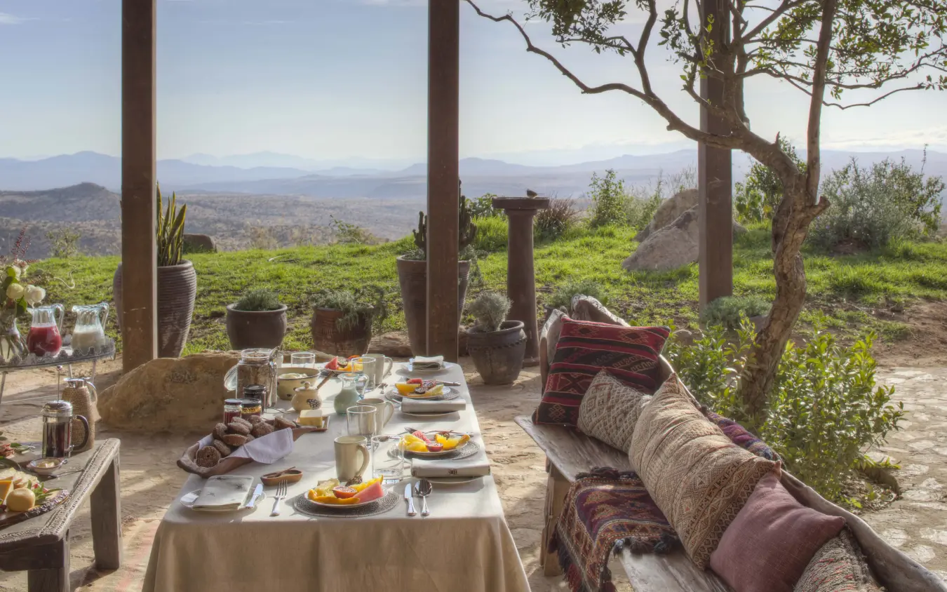 Outdoor dining terrace overlooking valley landscape, Lengishu House, Laikipia Highlands, Kenya